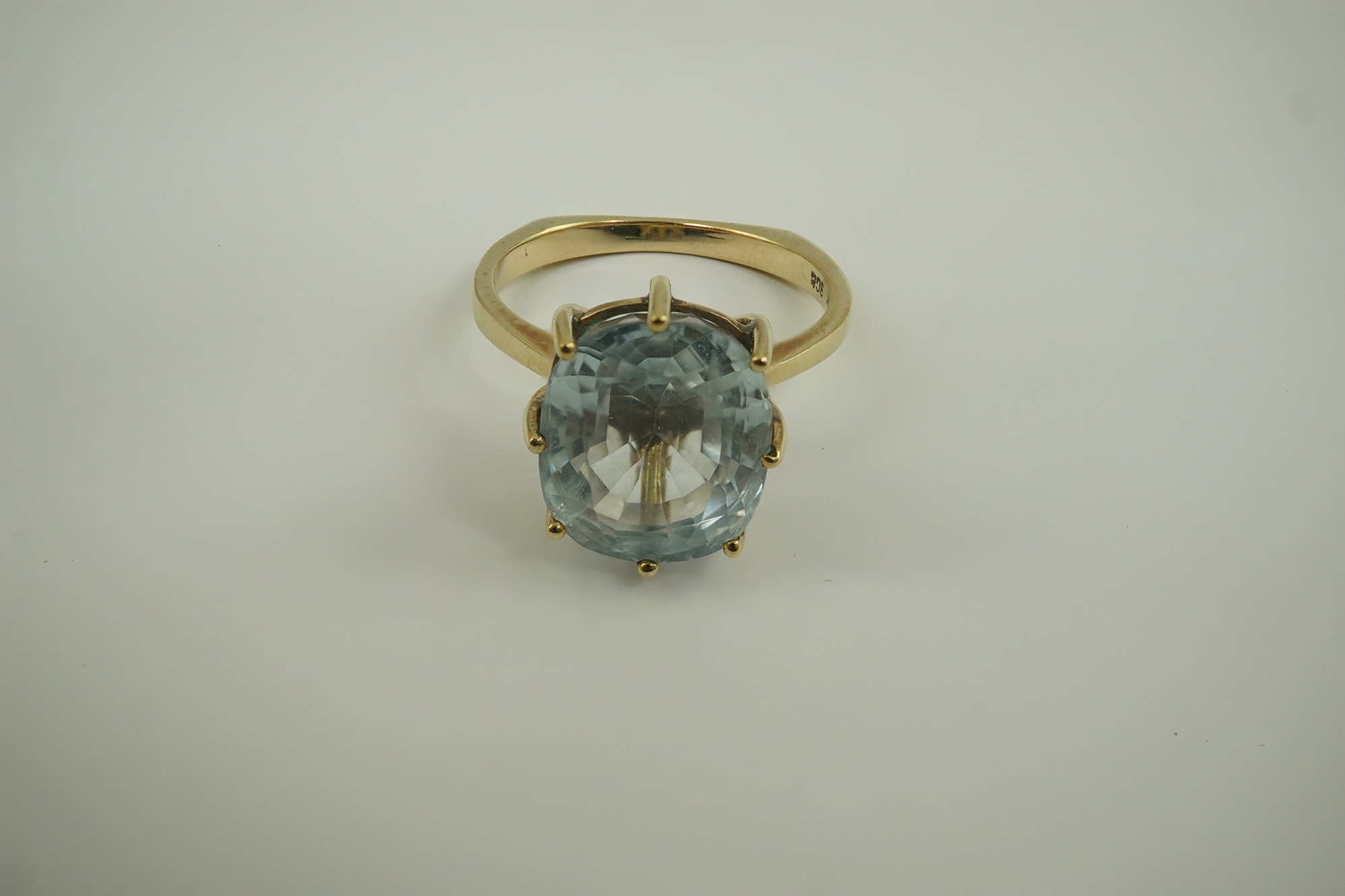 A 1970's 9ct gold and single stone oval cut aquamarine set dress ring